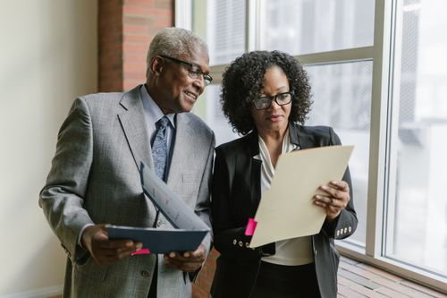 Two coworkers reviewing documents together